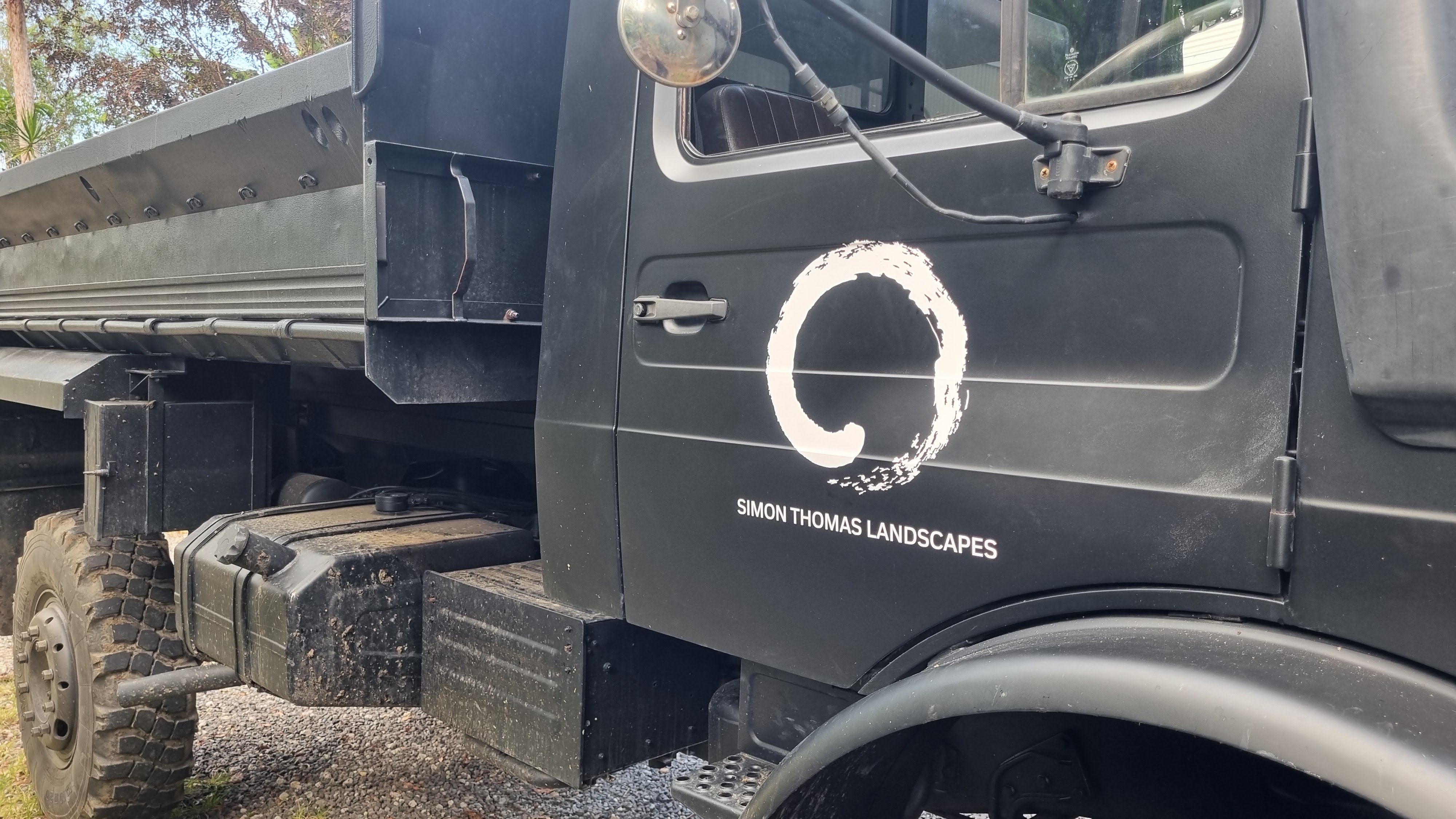 Cut vinyl business logo on a work truck door
